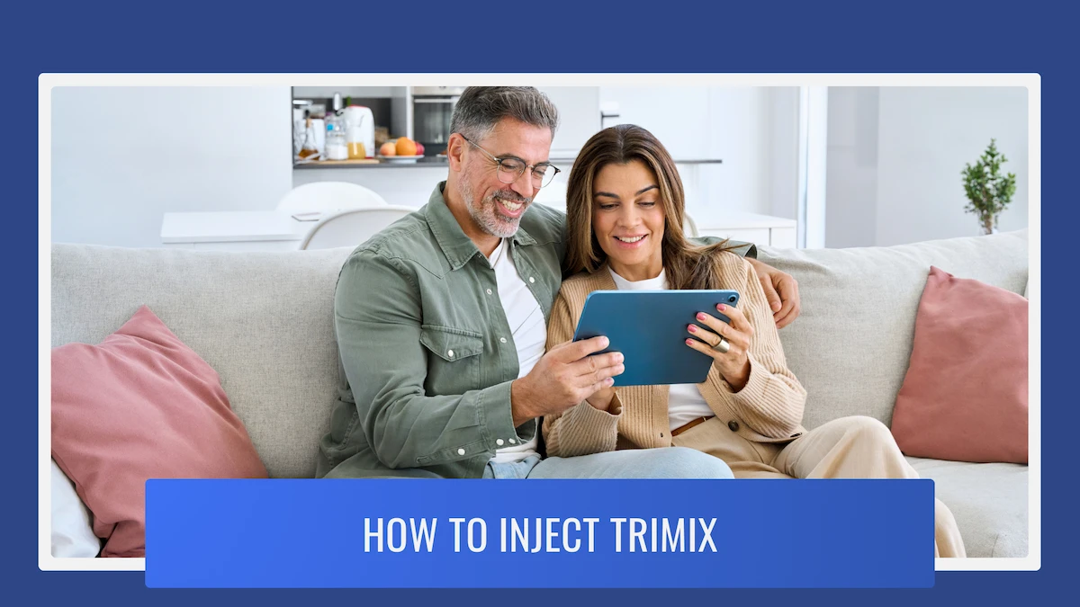 Middle aged couple sitting on the couch looking at a tablet