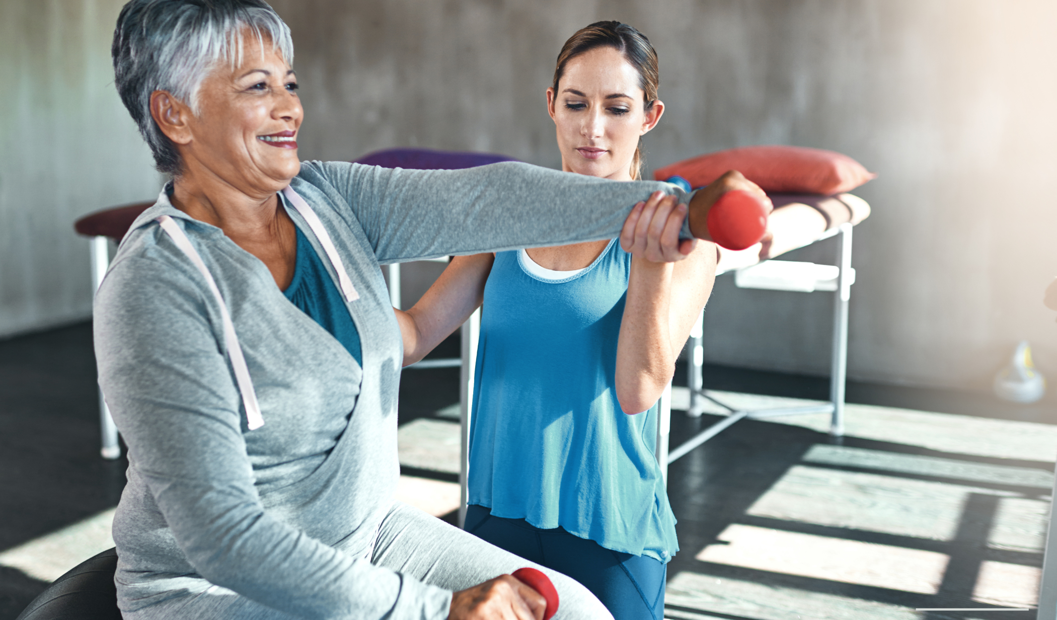 A trainer helping a woman exercise.