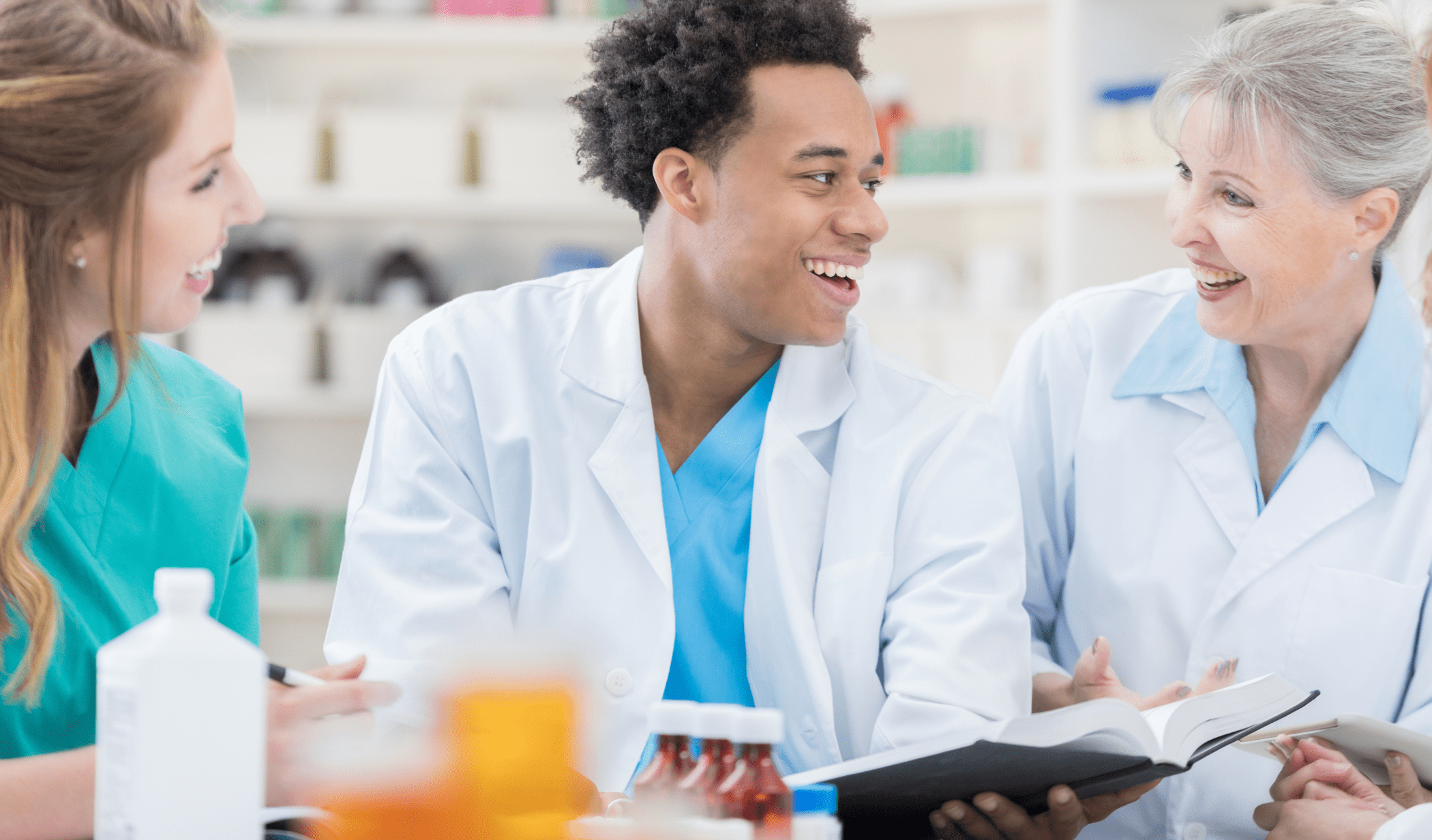 Three healthcare professionals discussing compounded semaglutide with B12