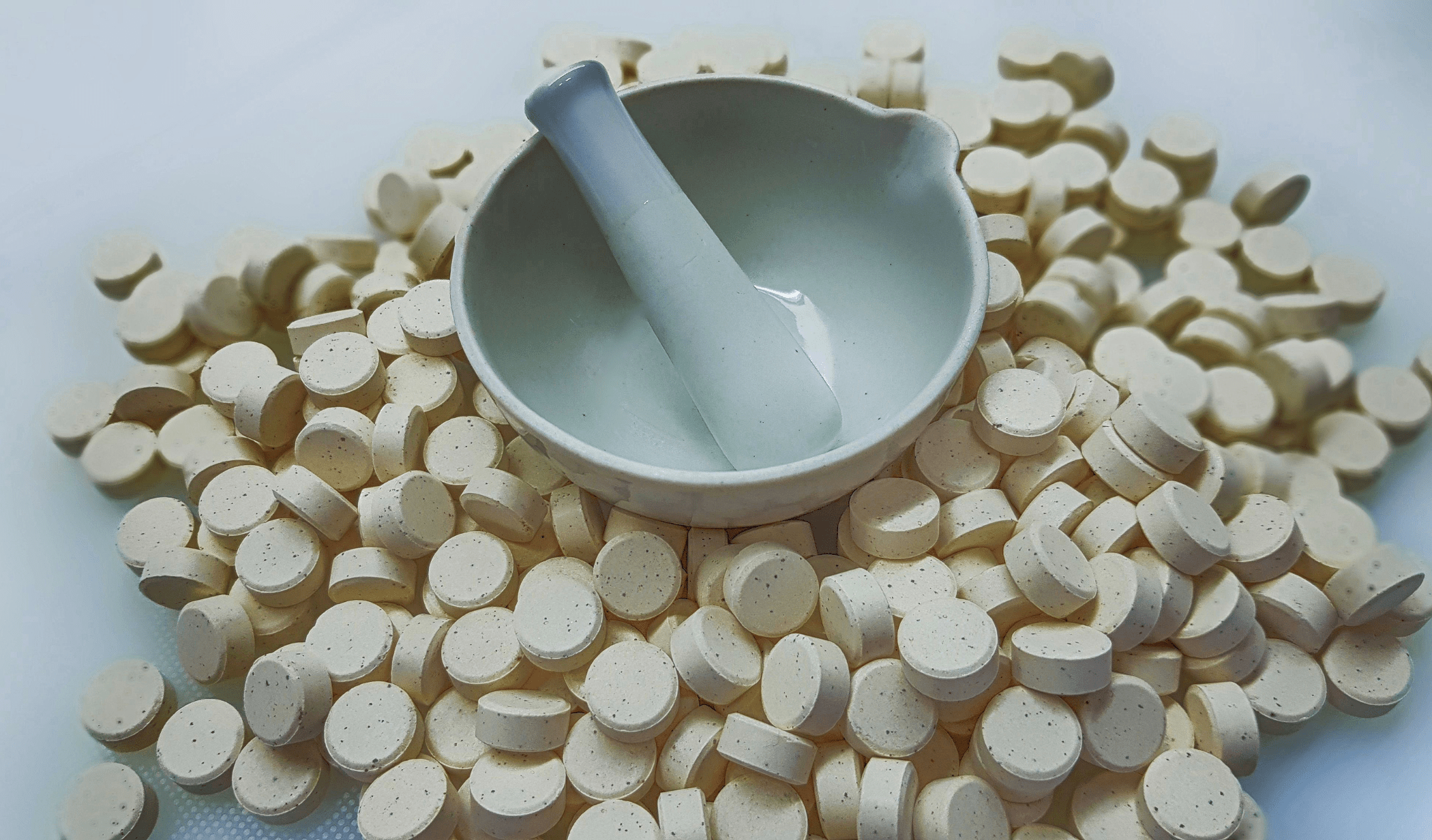 Tablets and a mortar and pestle.