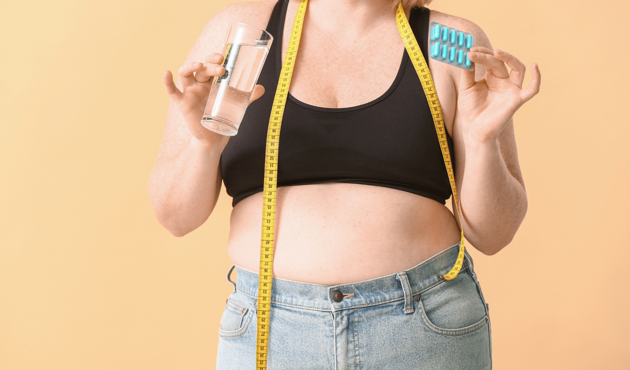 A woman with a tape measure and weight loss pills.