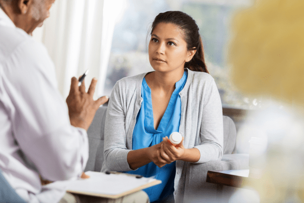 A woman talking with a doctor