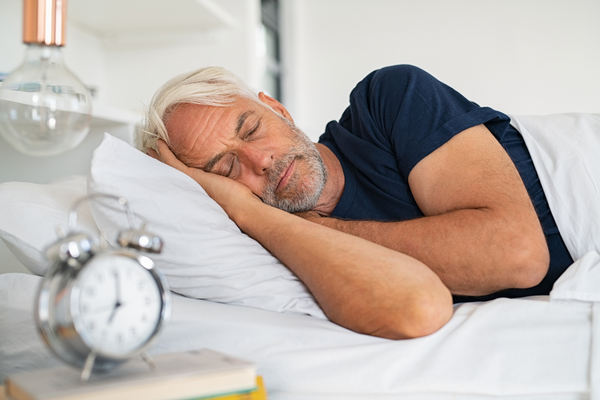 Man sleeping in bed reaping sermorelin benefits