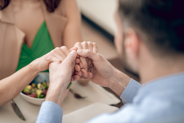 man and woman holding hands