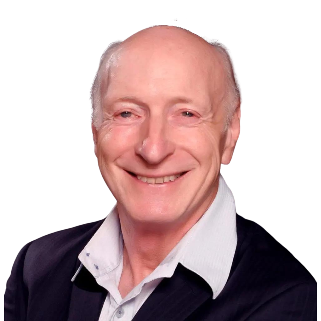 A smiling older man with light skin, short white hair, and a receding hairline, wearing a dark blazer over a light collared shirt, exudes resilience as he poses against a plain black background.