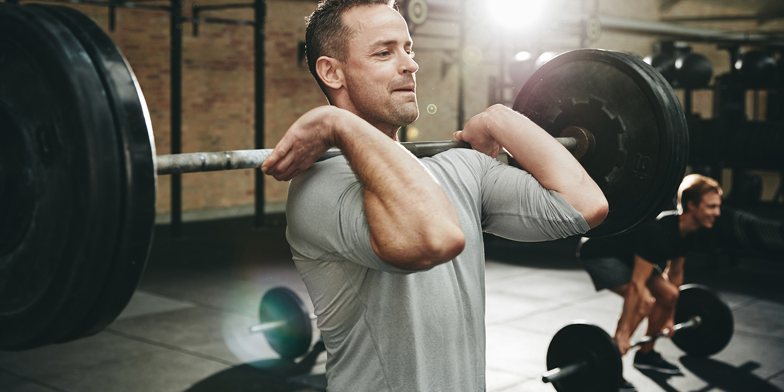Two people training in a gym, respecting personal space