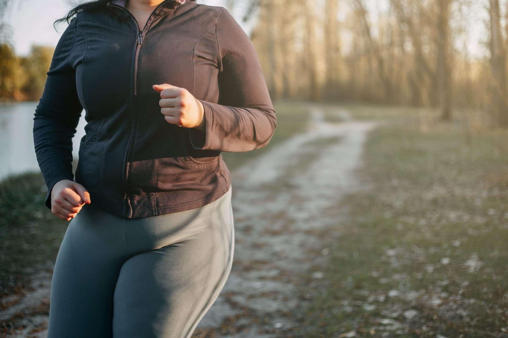 Overweight woman running outside