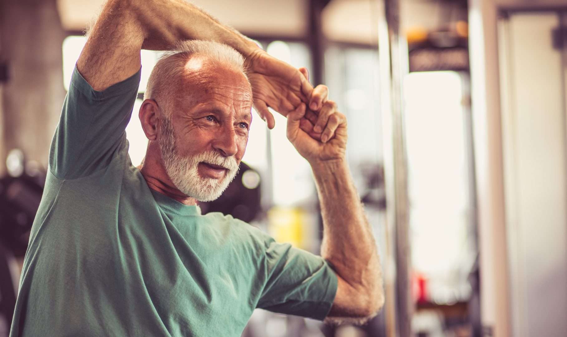 Older male stretching before working out while thinking about how sermorelin works