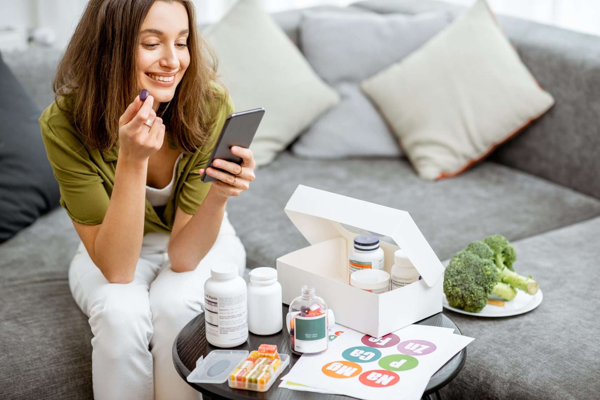 Woman sitting on a couch while on the phone with a doctor