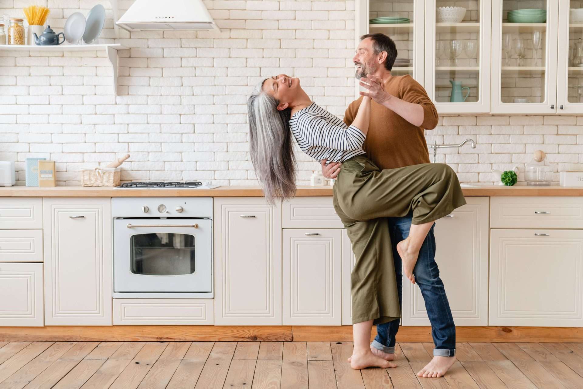 Man and woman in the kitchen, dancing