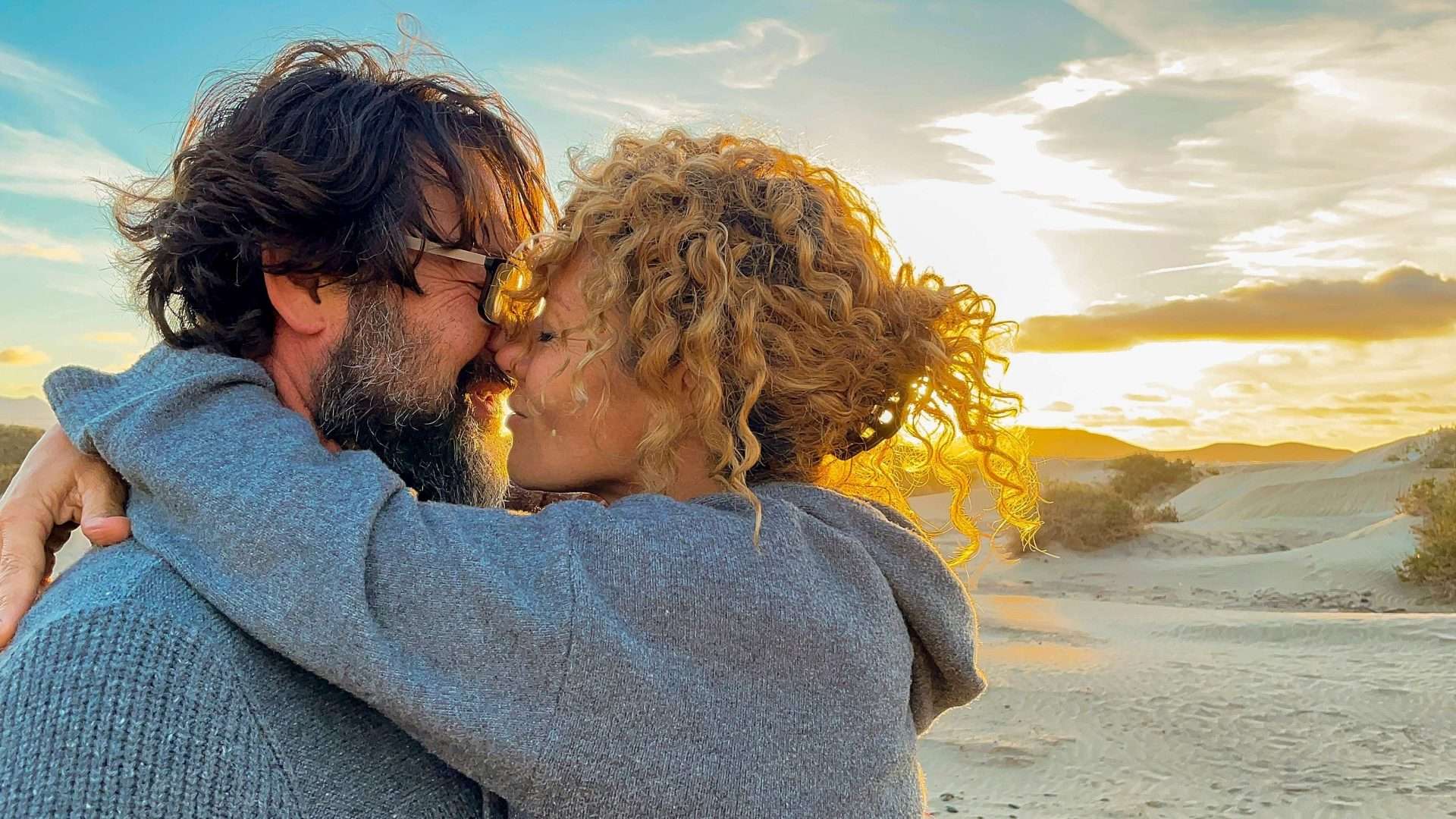 A couple embracing on the beach at sunset