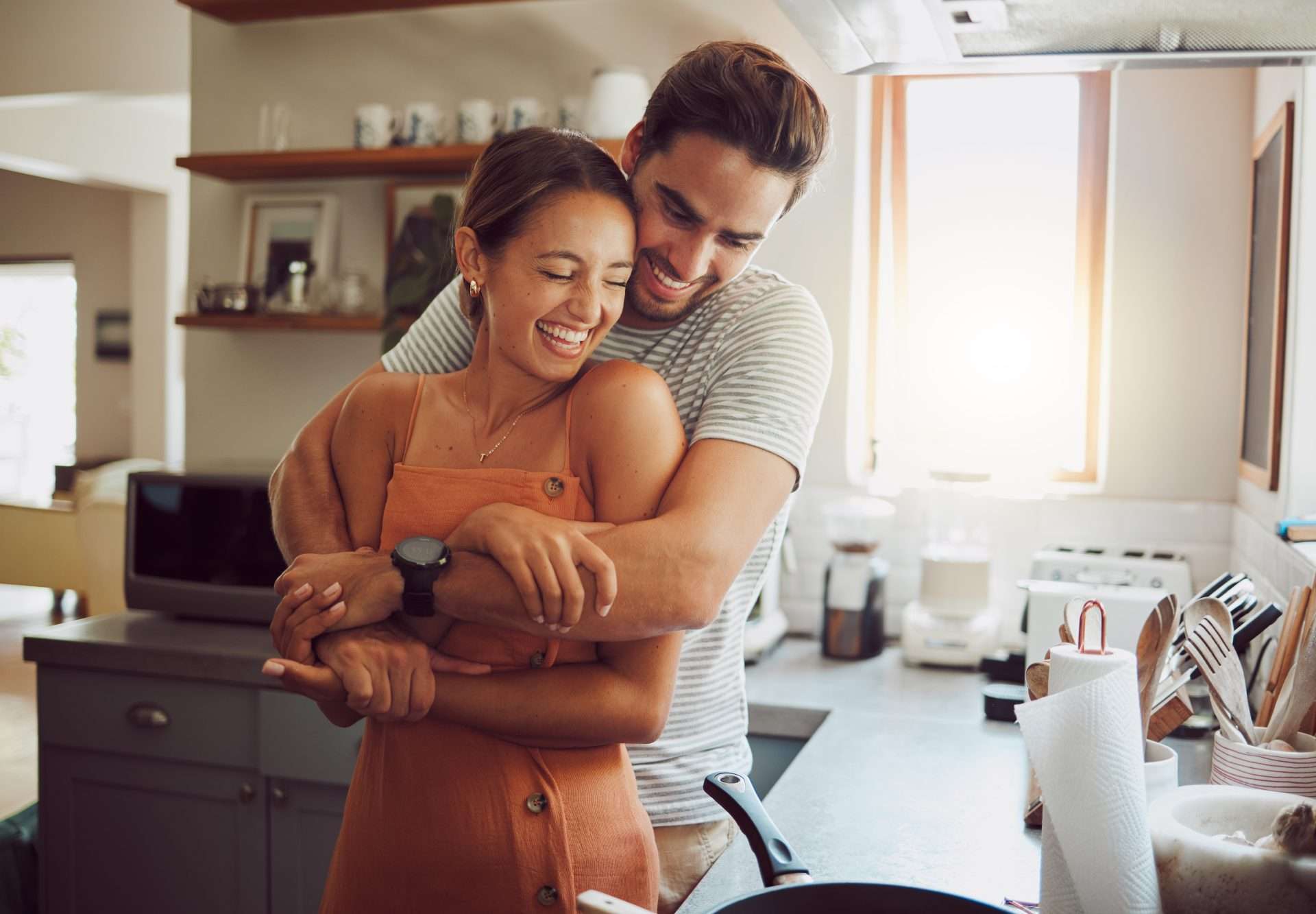 A man hugging a woman from behind