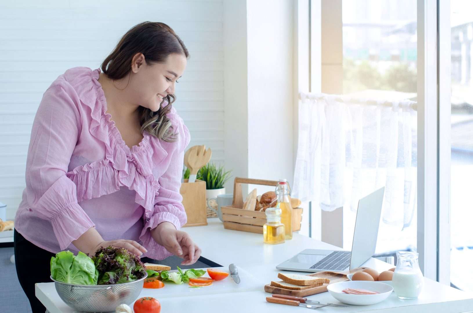 Overweight woman making a meal with healthy foods