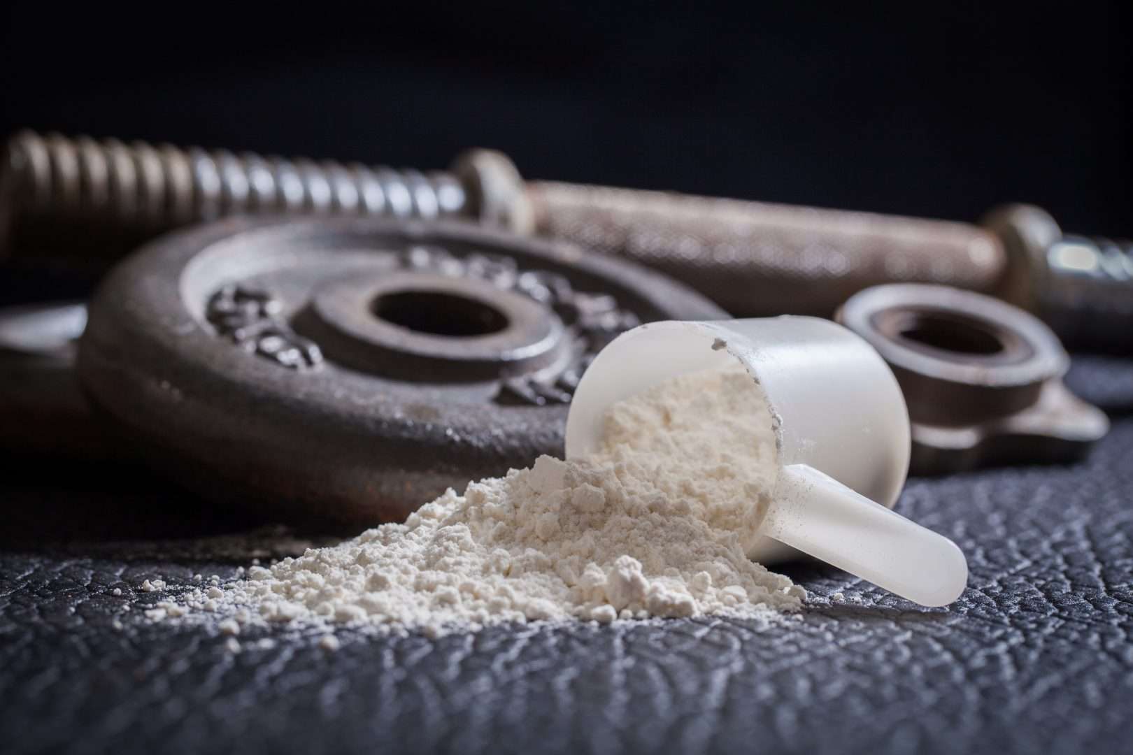 Protein powder next to some weights