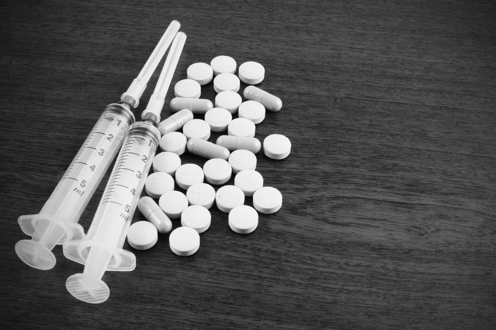 Pills and Syringes on a black background