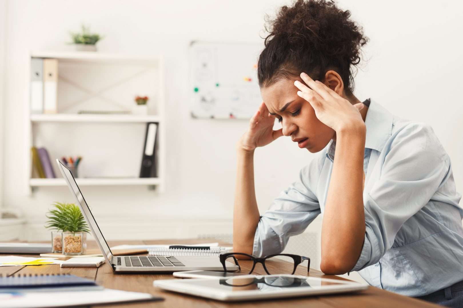 A woman trying to work with a headache