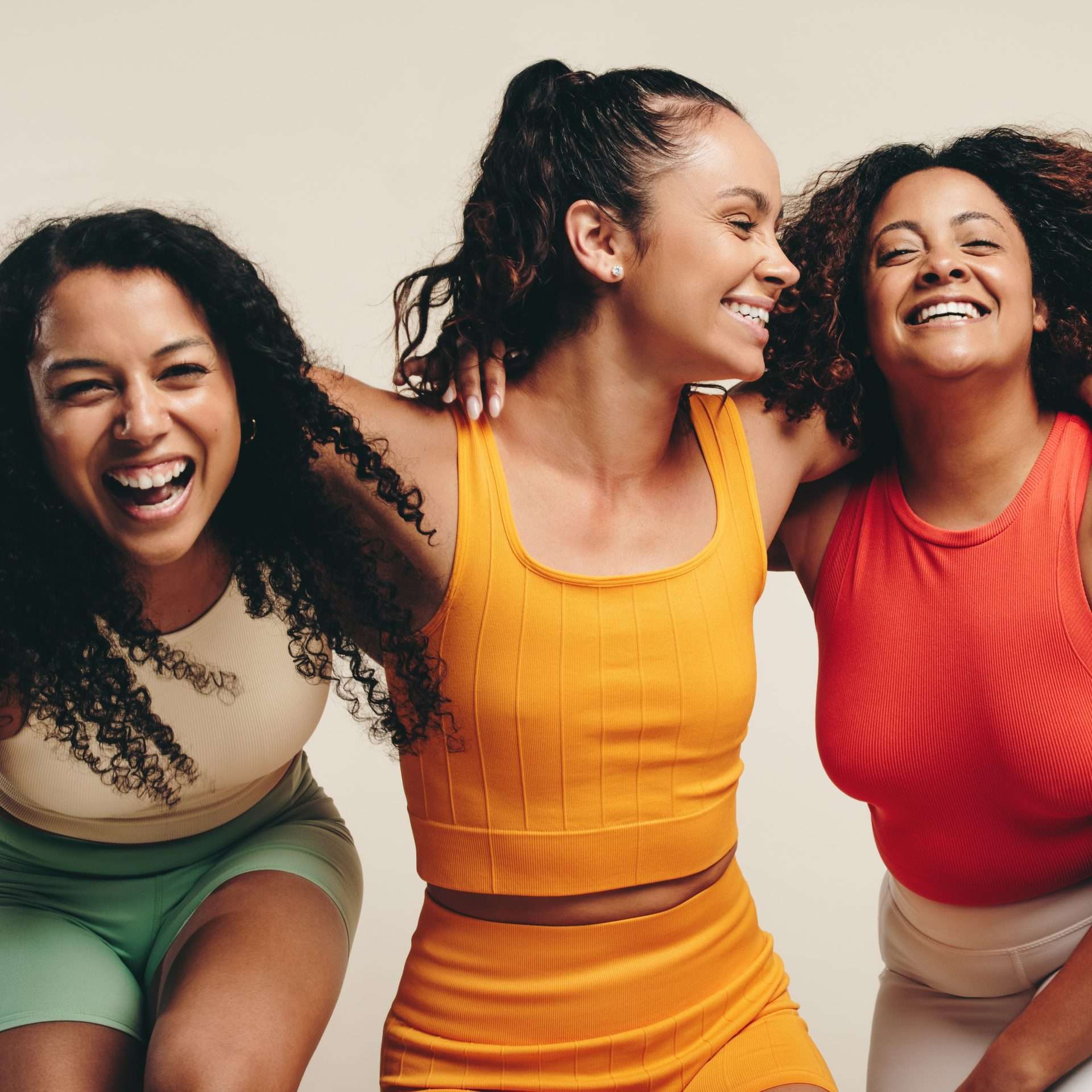 Three women happy smiling, in athletic clothes