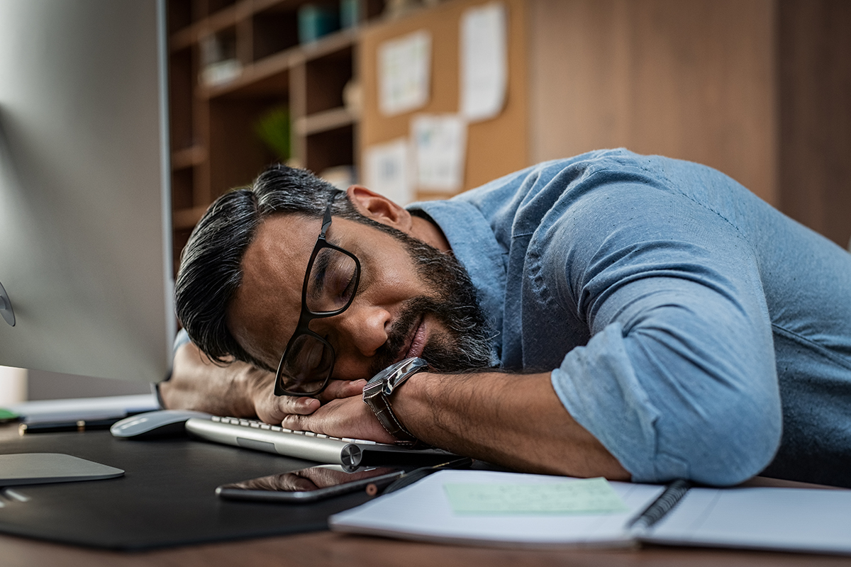 A man sleeping at the desk