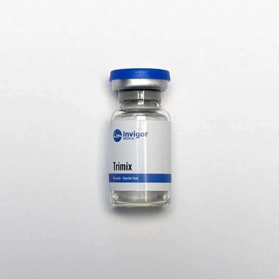 A clear vial labeled Trimix by Invigor Medical with a blue and silver cap, standing upright on a plain white background. For related treatments, you can also Buy Enclomiphene Online for convenient access to mens health solutions.